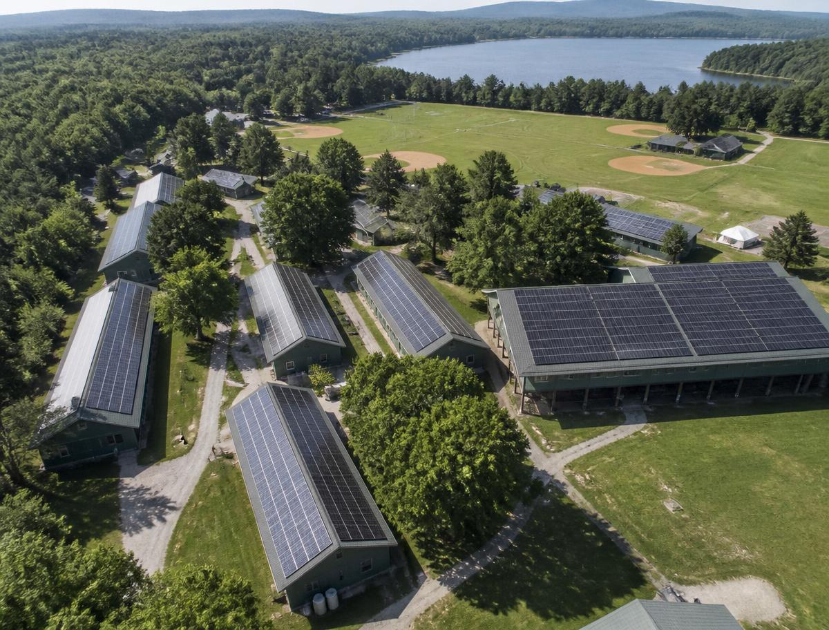 Nonprofit camps & retreat centers with a rooftop solar array